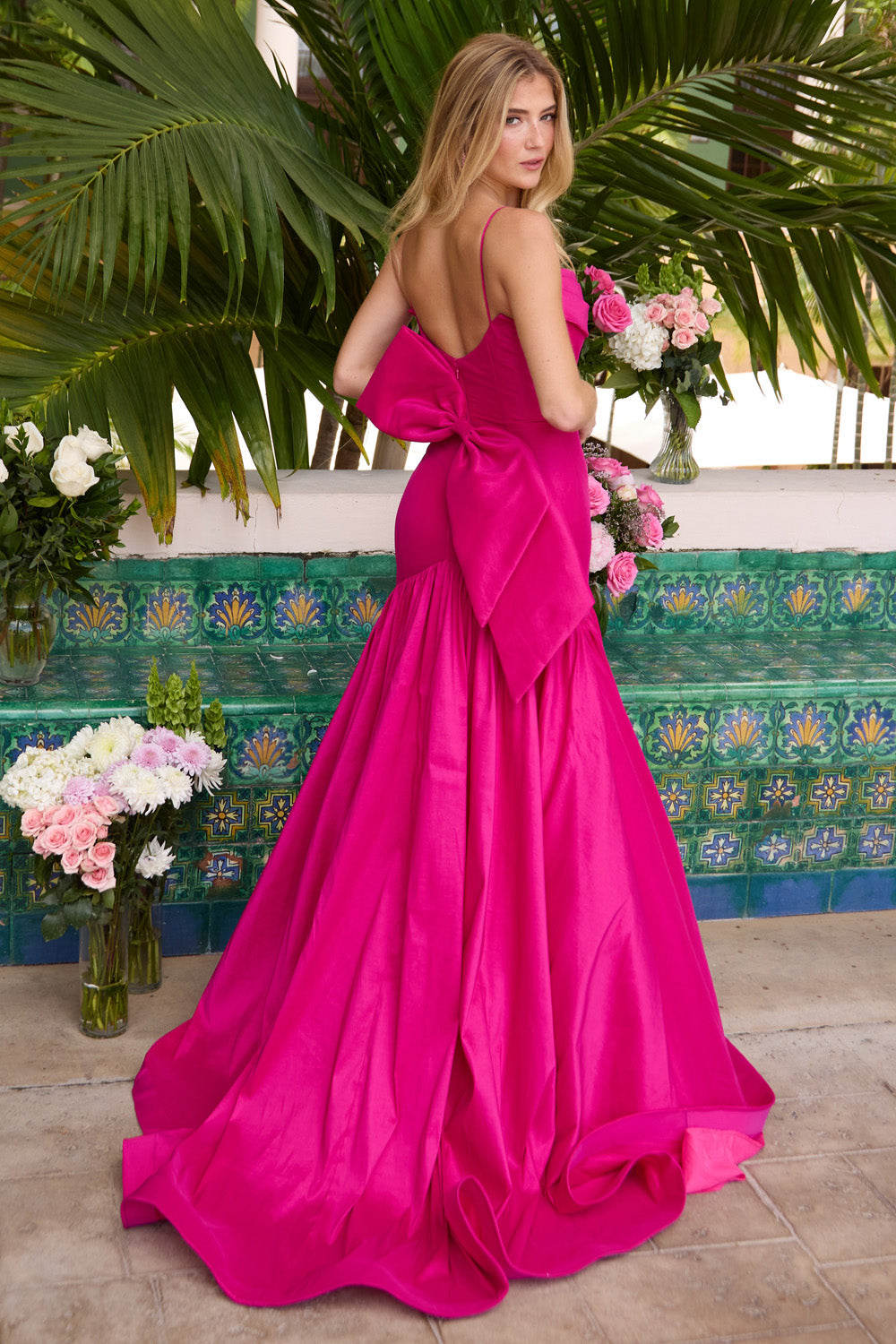 Ava Presley 26422 Magenta mermaid prom dress with a dramatic bow and open back view.