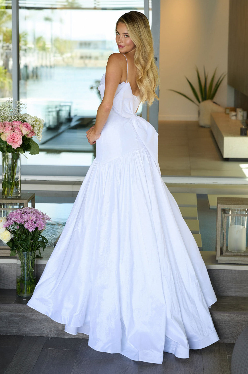 Ava Presley 26422 White A-line prom dress with a bow detail and open back, back view.