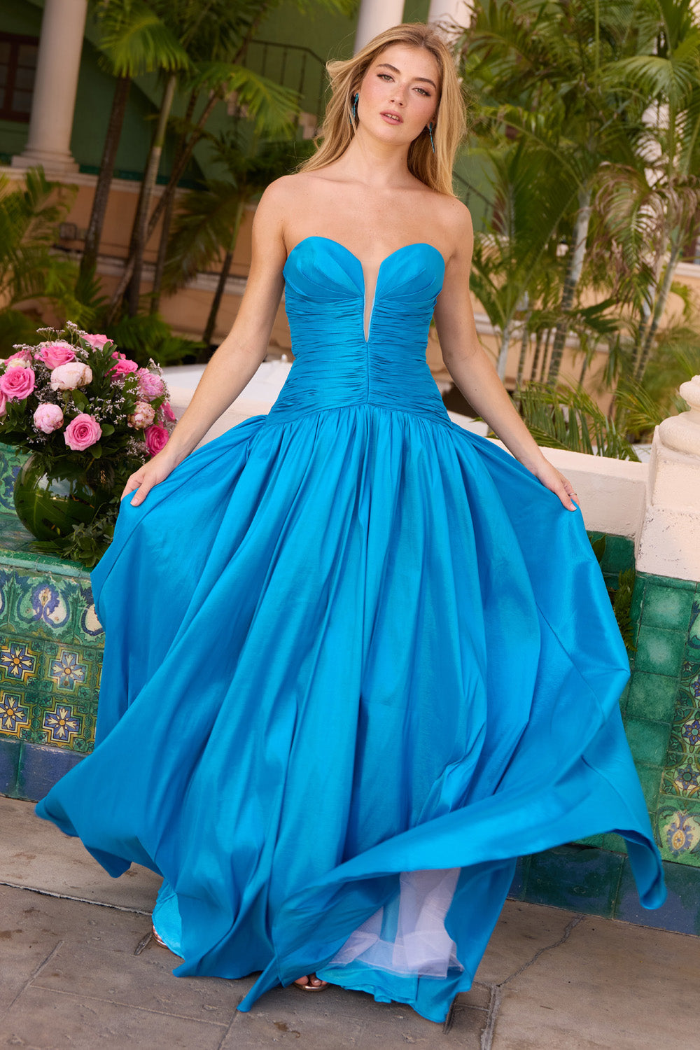 Ava Presley 42261 Ocean blue A-line prom dress with a plunging neckline and flowing skirt.