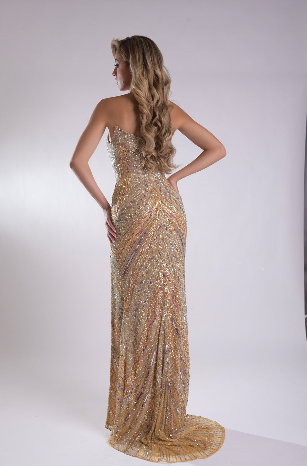 Jasz Couture 7910 Gold mermaid prom dress with sequins and a stunning lace-up back, back view.