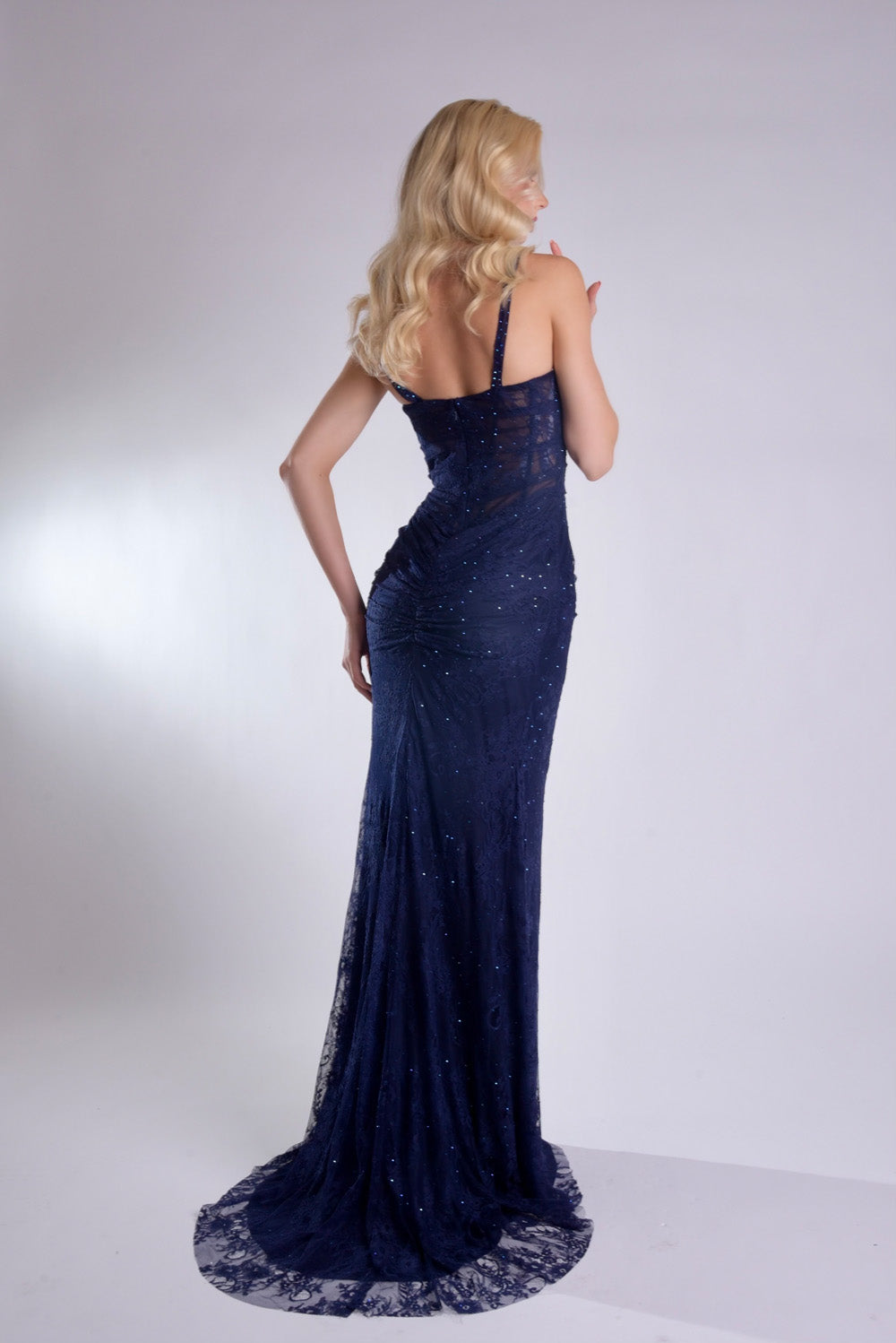 Jasz Couture 7913 Navy fitted prom dress with a lace-up back and shimmering sequins, back view.
