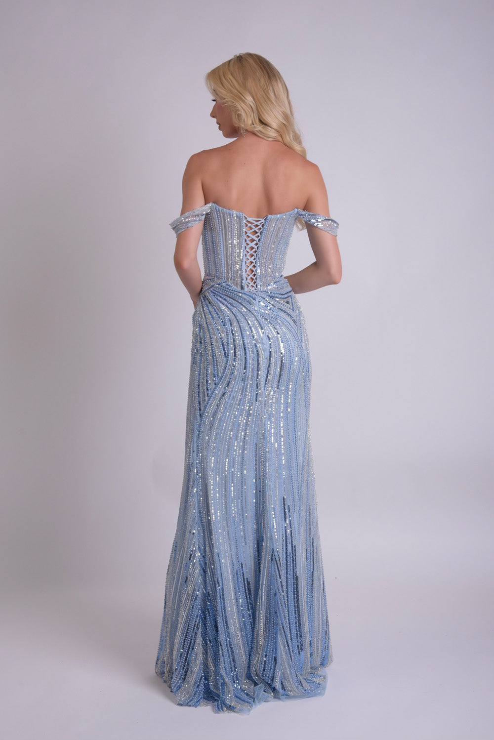 Jasz Couture 7921 Light blue mermaid prom dress with a lace-up back and shimmering sequins, back view.