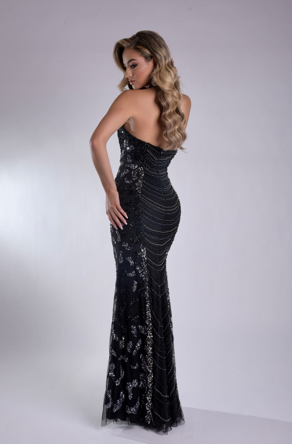 Jasz Couture 7925 Black mermaid prom dress with sequins and a lace-up back, back view.