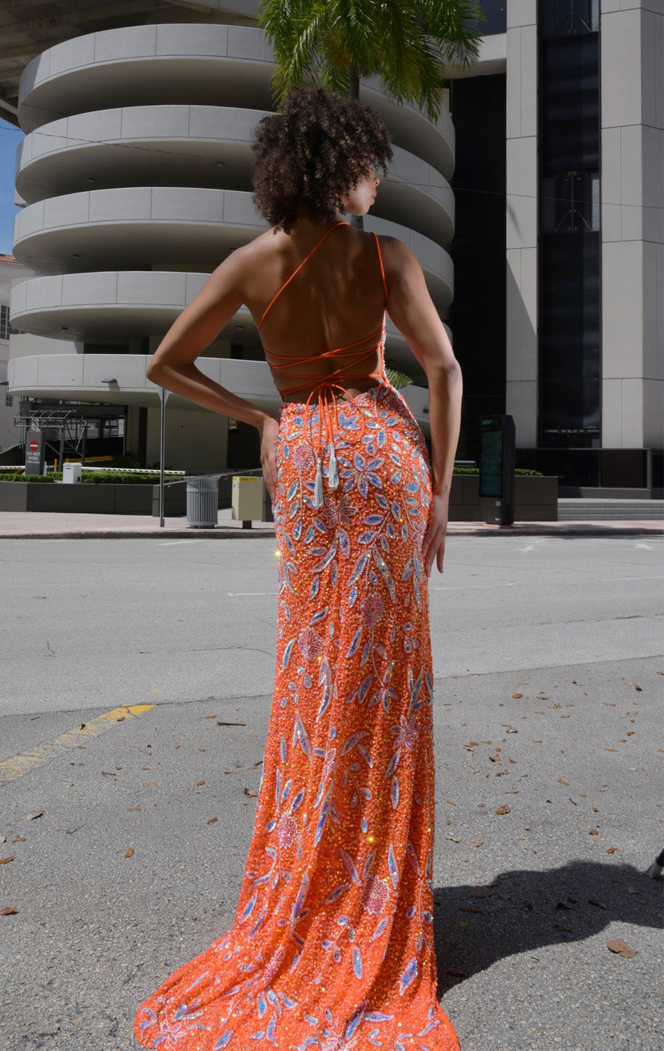 Jasz Couture 7928 Back view of an orange prom dress with intricate beading and a lace-up back.
