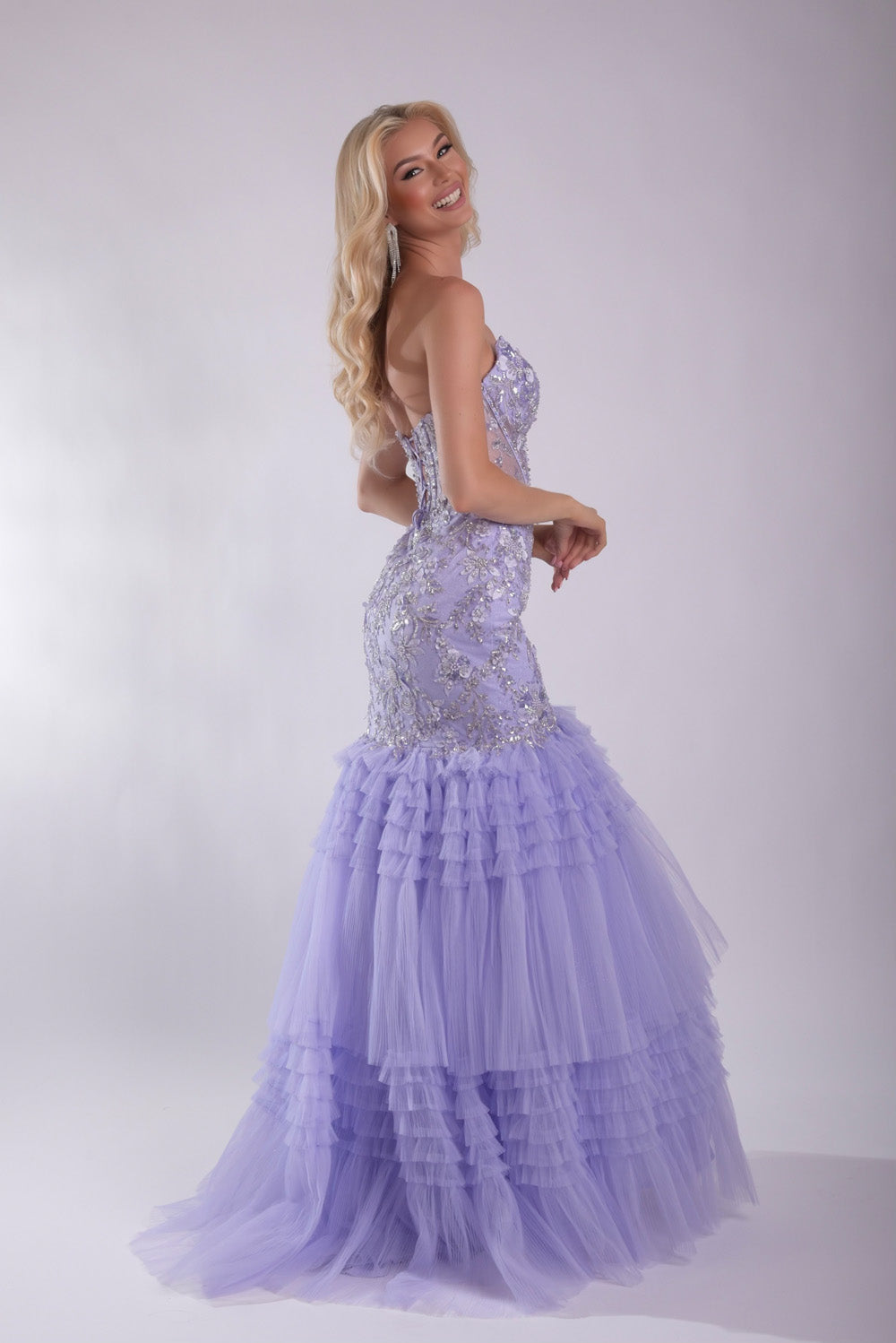 Jasz Couture 7939 Lilac mermaid prom dress with sequins and layered tulle ruffles, side view.