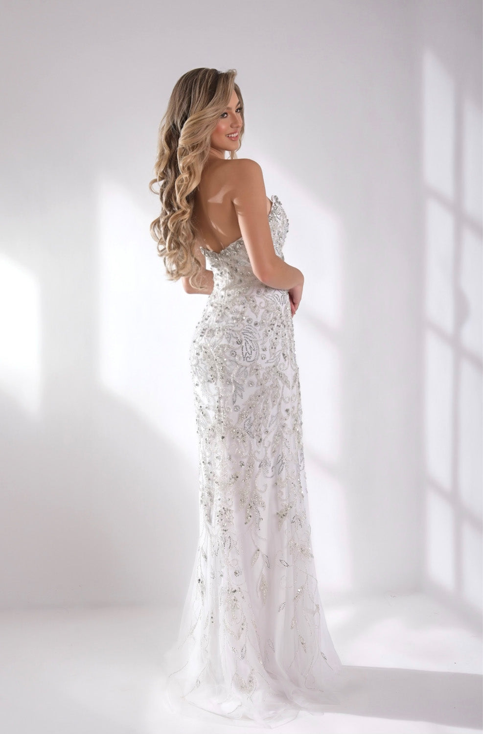 Jasz Couture 7944 White fitted prom dress with intricate beading and a stunning lace-up back.