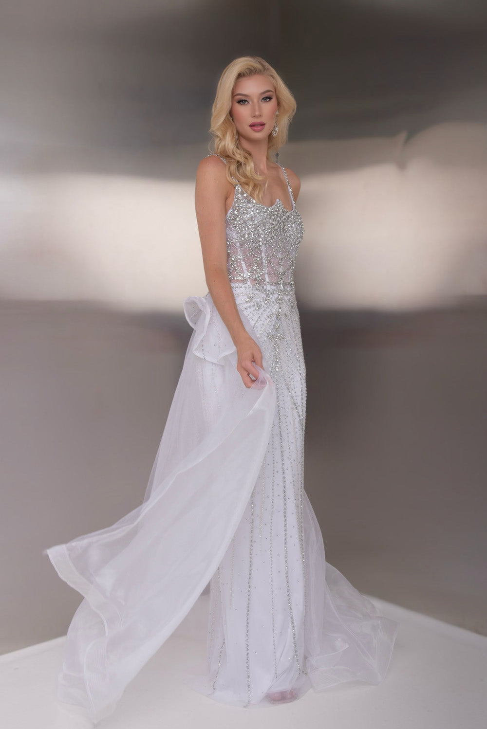 Jasz Couture 7946 White formal gown with beaded bodice and flowing train, front view.