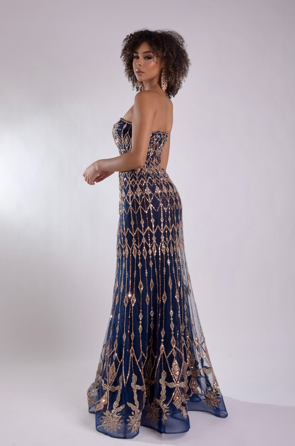 Jasz Couture 7947 Navy rose gold mermaid prom dress with intricate beading, side view.