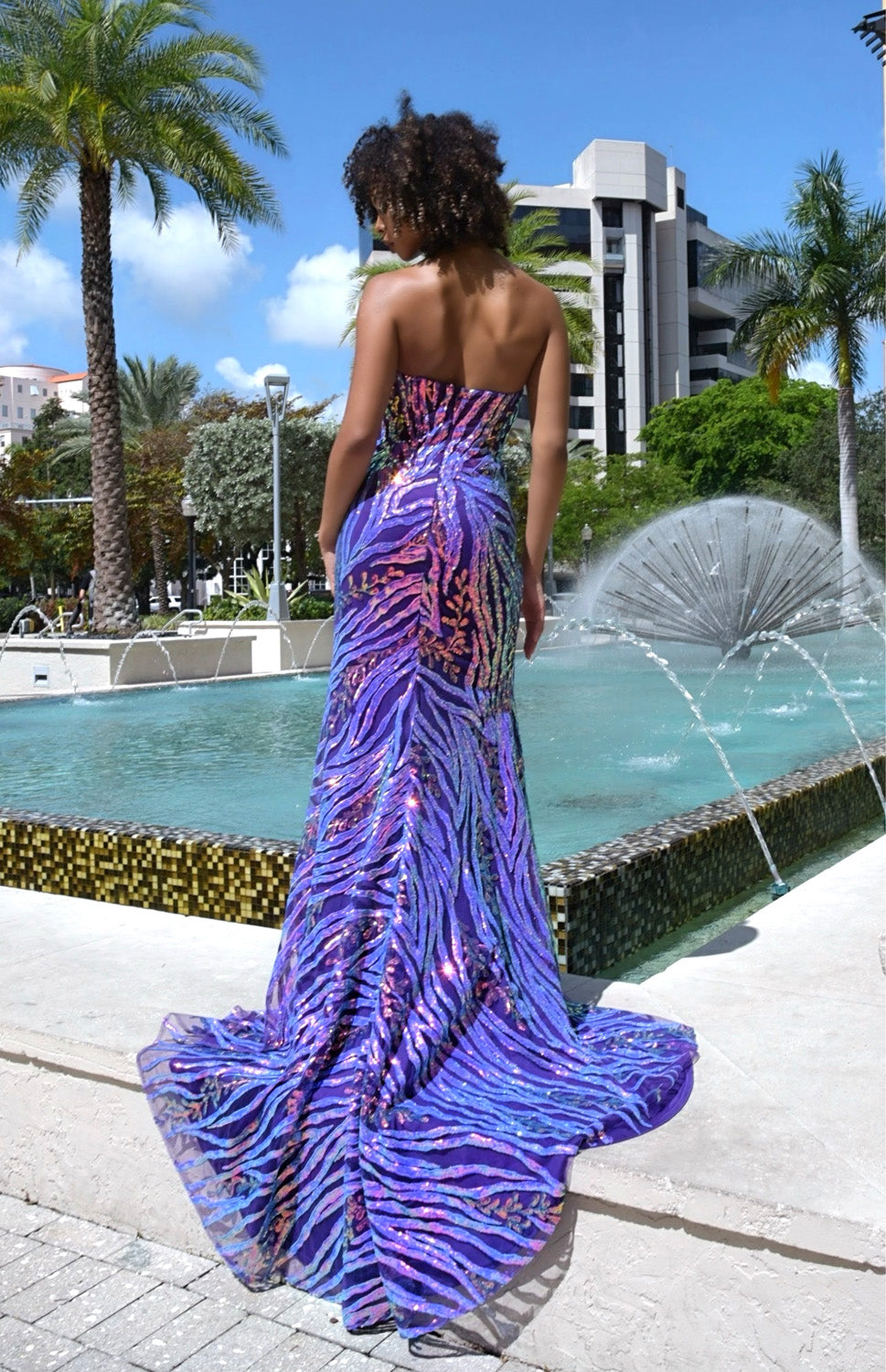 Jasz Couture 7949 Purple mermaid prom dress with sequins and a lace-up back, back view.