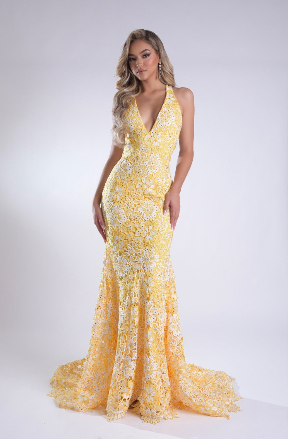 Jasz Couture 7955 Yellow lace mermaid prom dress with a plunging neckline and floral detailing.