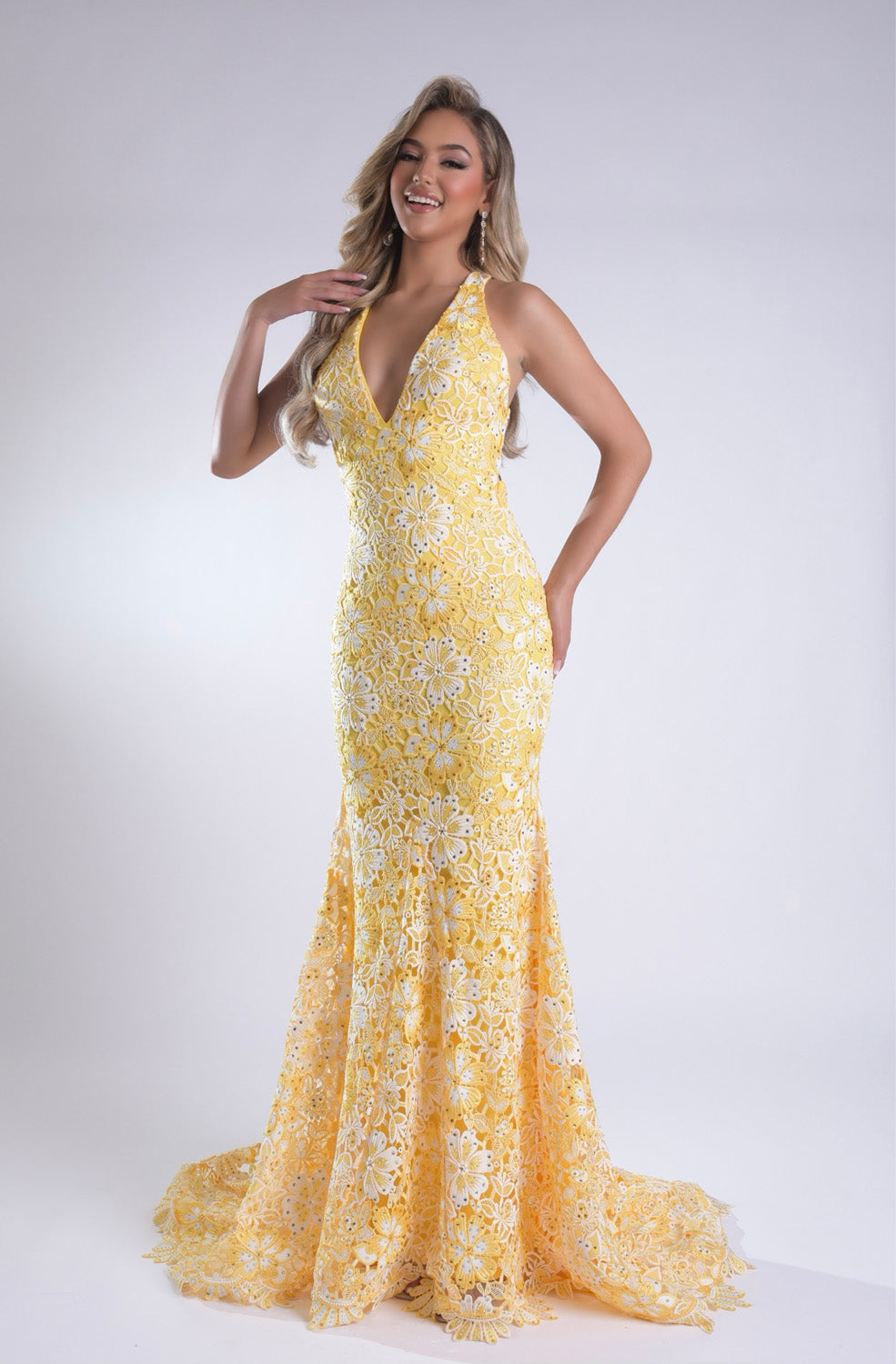 Jasz Couture 7955 Yellow mermaid prom dress with lace detailing and a plunging neckline, side view.