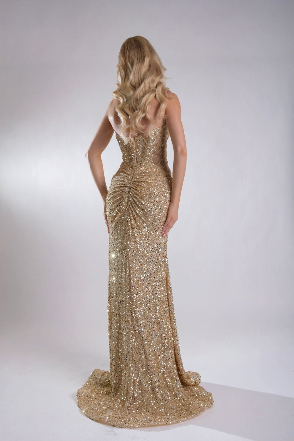 Jasz Couture 7969 Gold mermaid prom dress with sequins and a stunning lace-up back, back view.