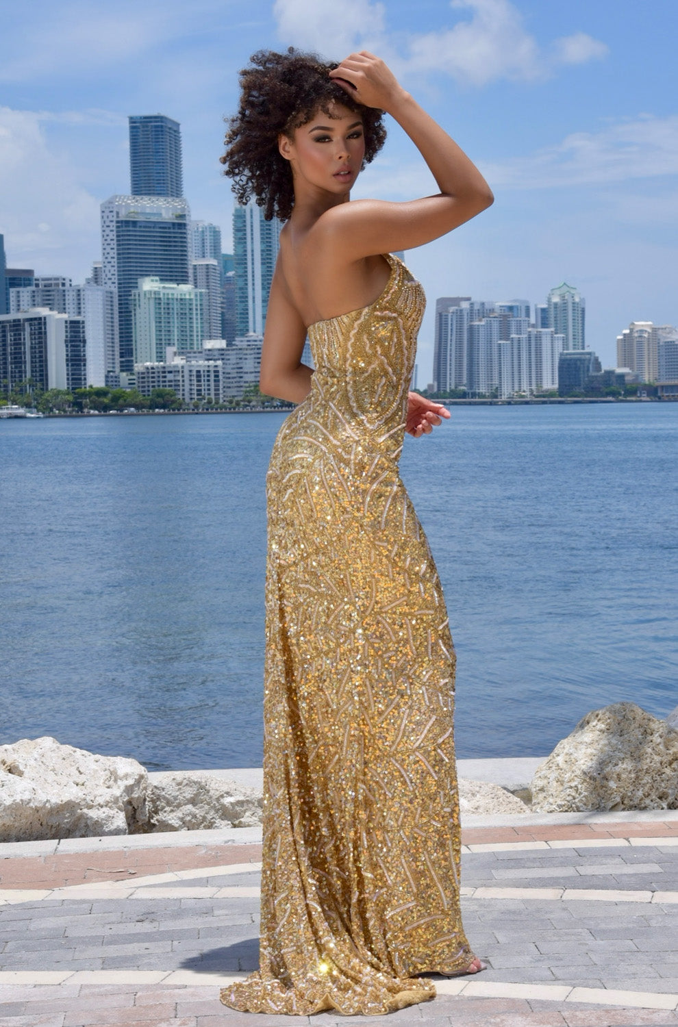 Jasz Couture 7976 Gold mermaid prom dress with intricate beading, featuring a back view.
