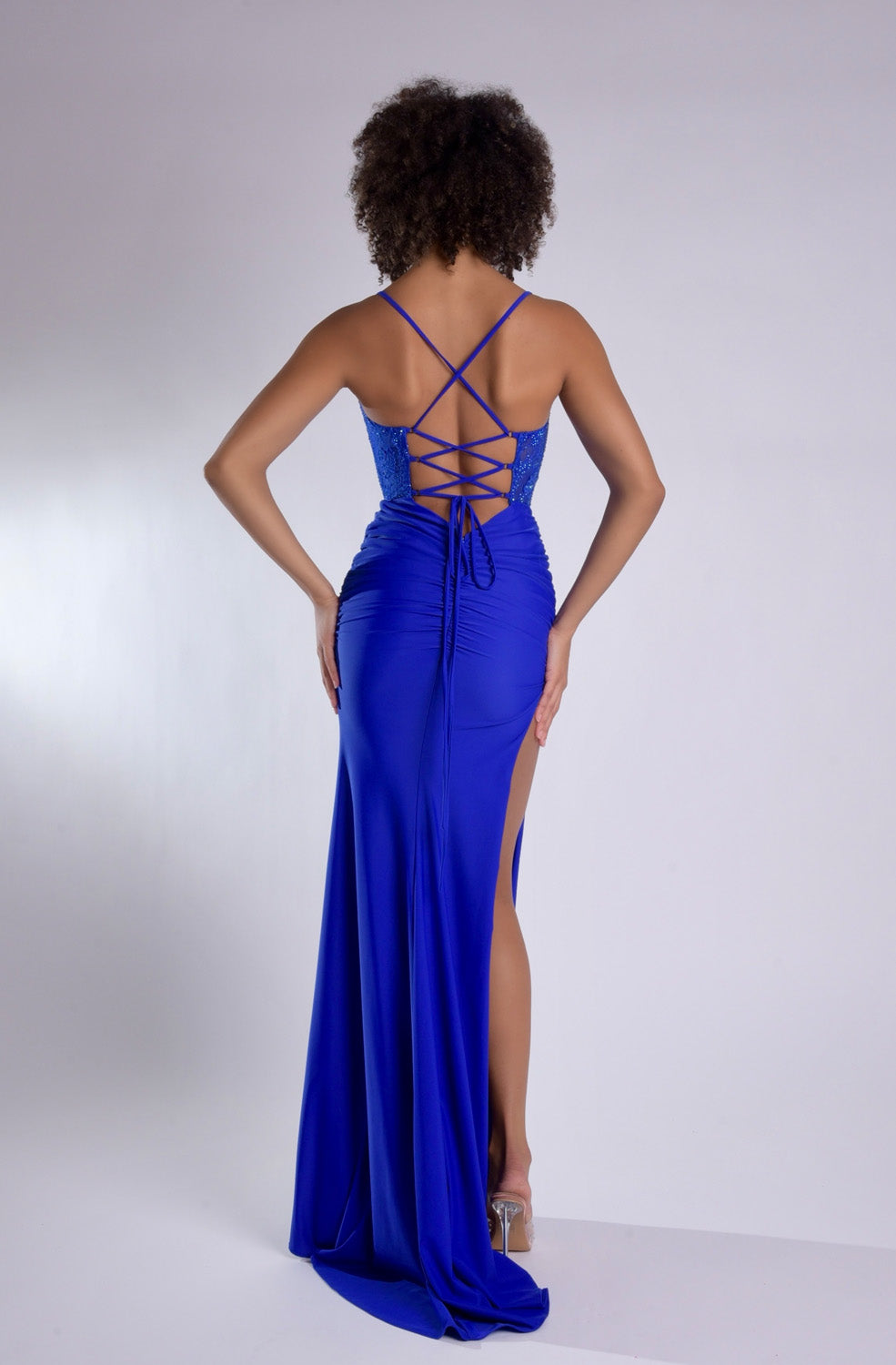 Jasz Couture 7986 Royal blue prom dress with a fitted silhouette and lace-up back, back view.