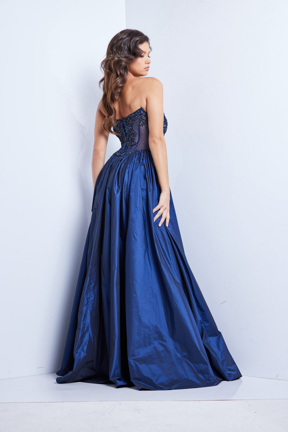 Jovani 26114 Navy A-line prom dress with intricate beading and a corset back, back view.