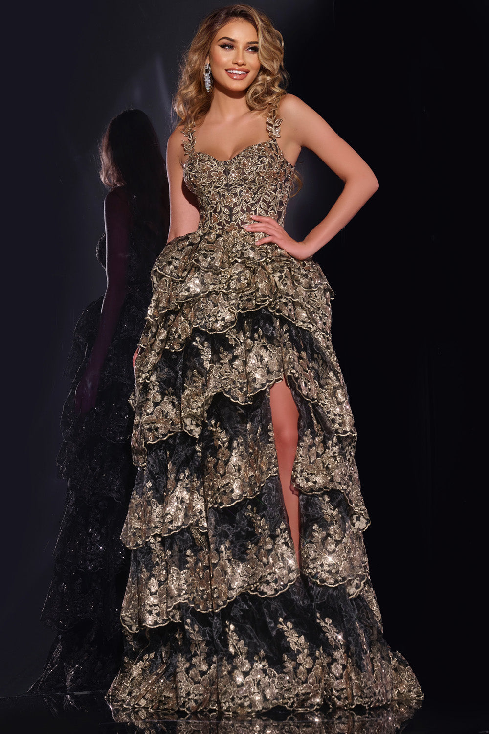 Jovani 37630 Black and gold mermaid prom dress with sequins and a thigh-high slit, front view.