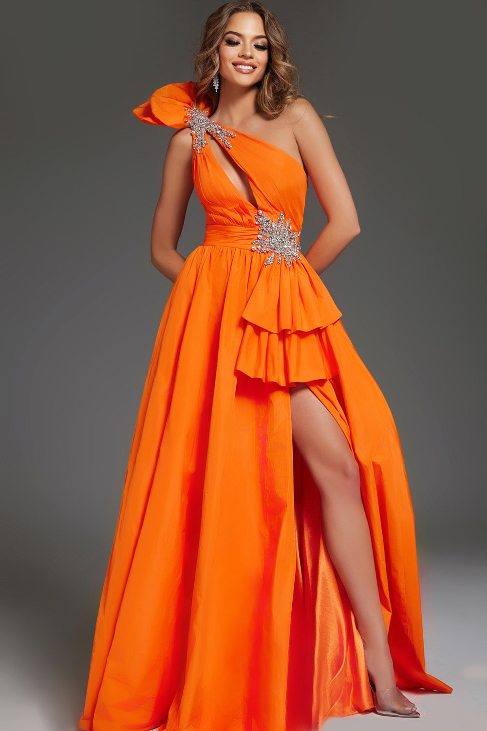 Jovani 40929 Orange A-line prom dress with a high slit and embellished shoulder detail.