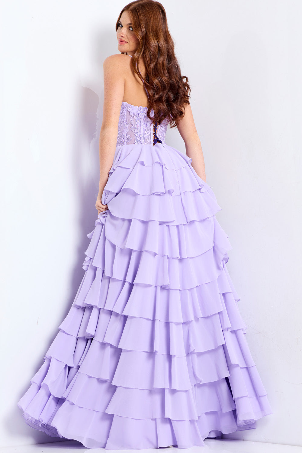 Jovani 44543 Lilac formal gown with layered ruffles and lace-up back, back view.