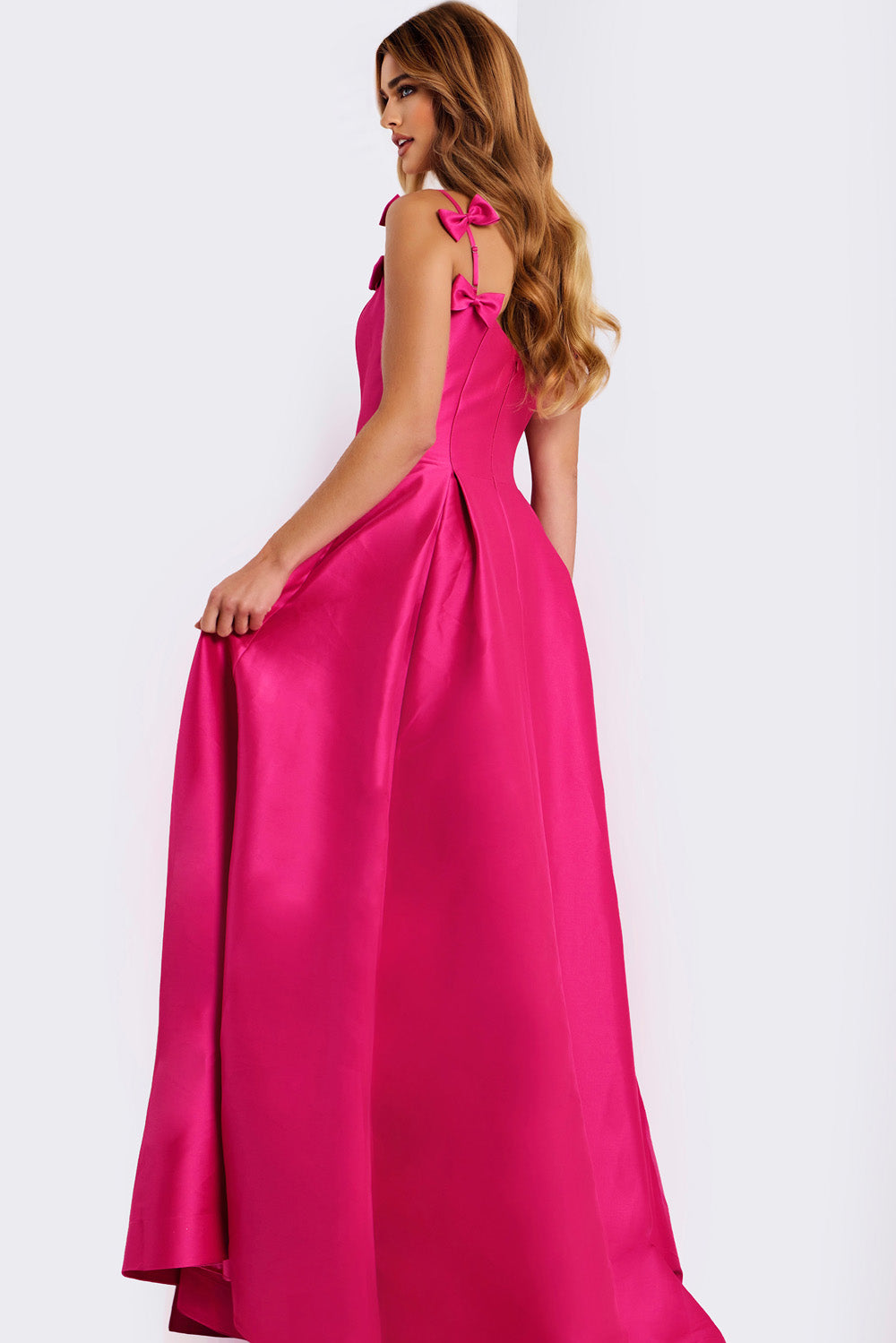 Jovani 46468 Candy pink A-line prom dress with bow straps and a flowing skirt, back view.