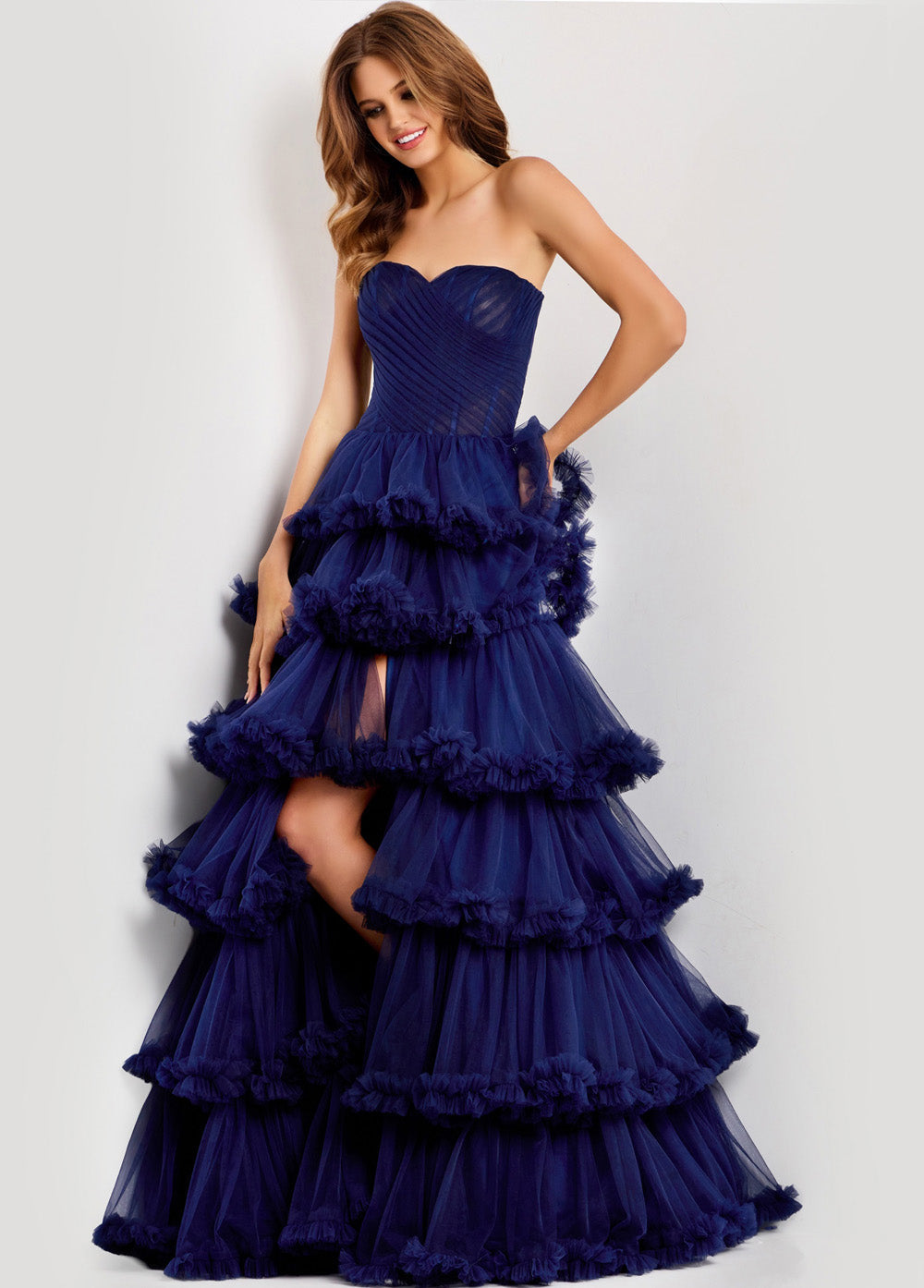 Jovani 47139 Navy mermaid prom dress with ruffled layers and a thigh-high slit.