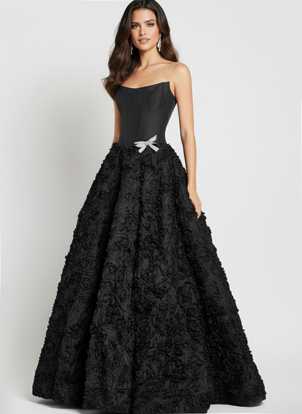 Jovani 47695 Black ballgown prom dress with floral texture and a sparkling bow detail.