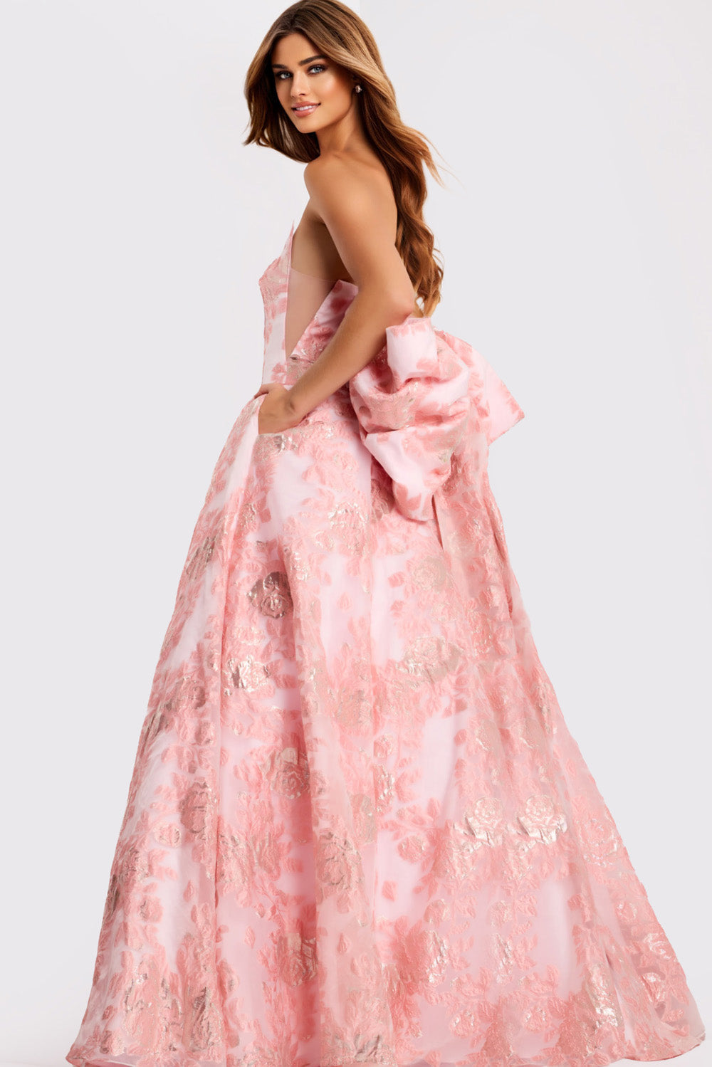 Jovani 47702 Light pink ballgown with floral detailing and a dramatic bow, side view prom dress.