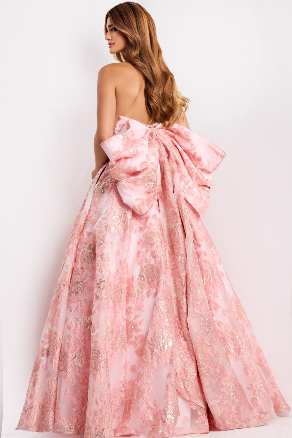 Jovani 47702 Light pink ballgown with a large bow and intricate floral detailing, back view prom dress.