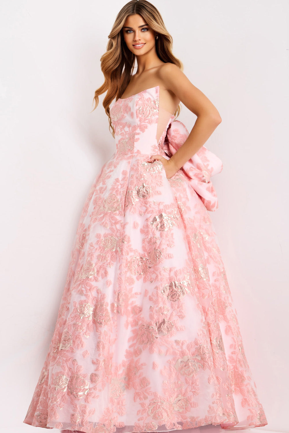 Jovani 47702 Light pink ballgown with floral embroidery and a dramatic bow, front view prom dress.