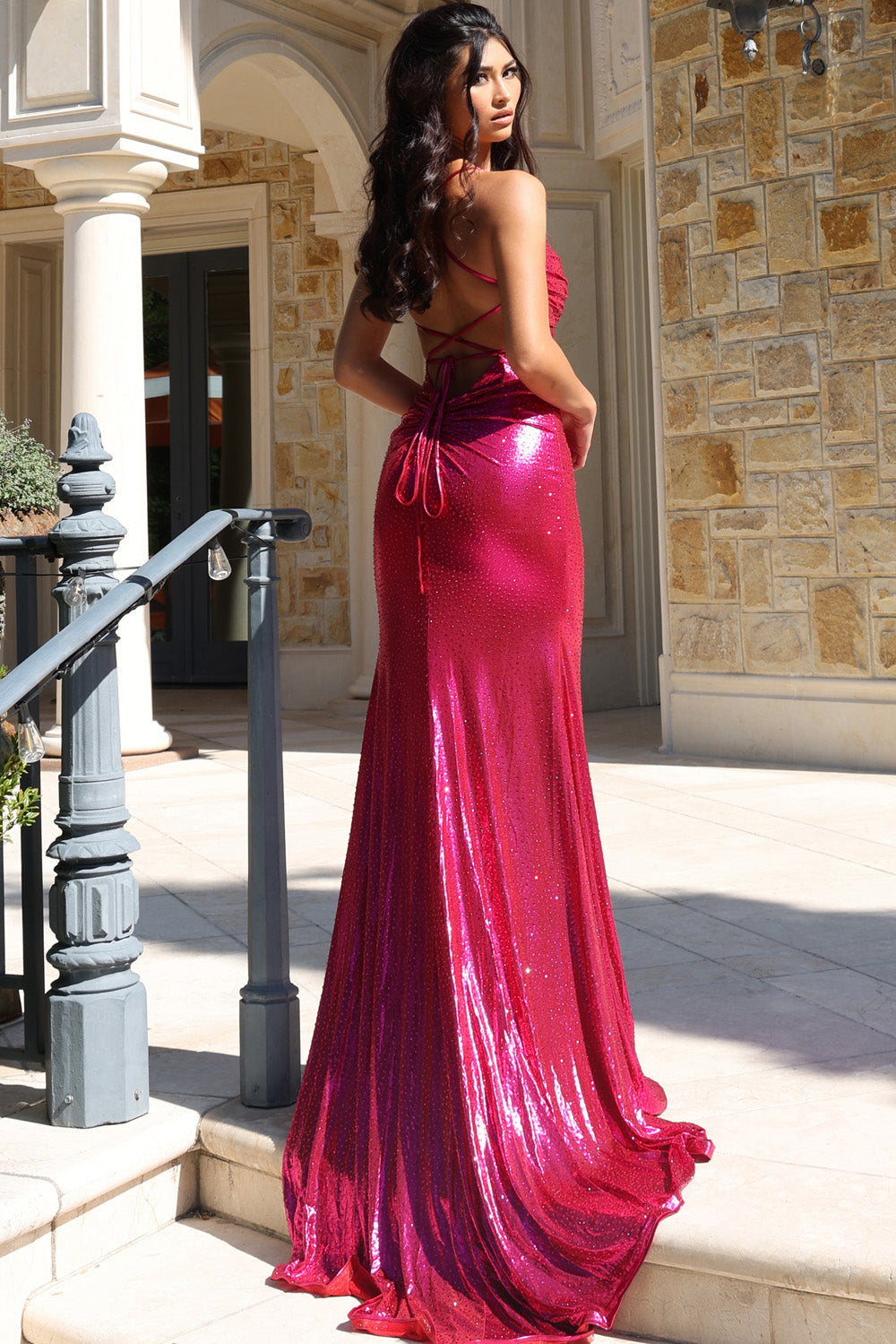 Jovani 47752 Fuchsia mermaid prom dress with a lace-up back and shimmering sequins, back view.