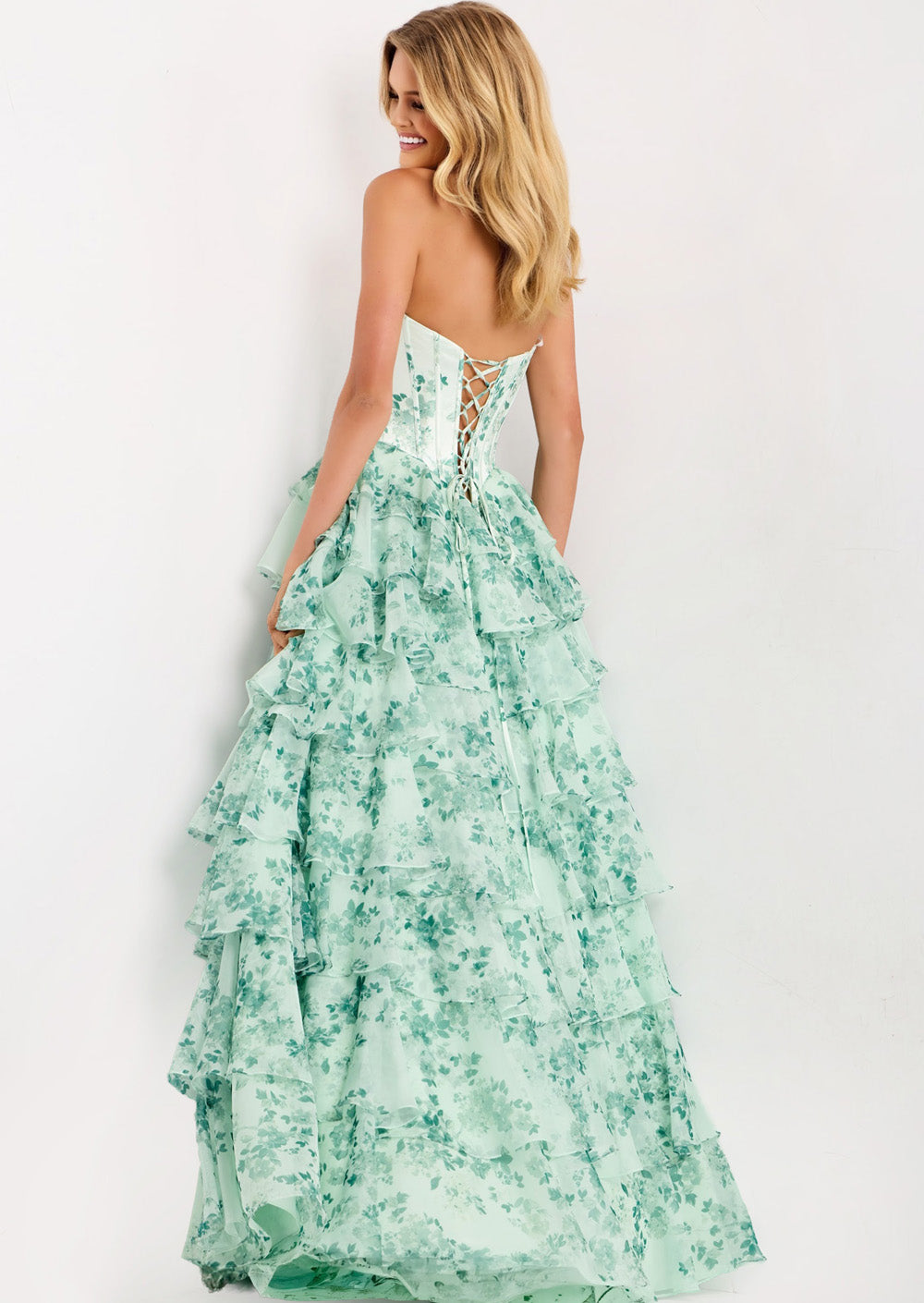 Jovani 48772 Blush and green floral A-line prom dress with a lace-up back and ruffled layers.