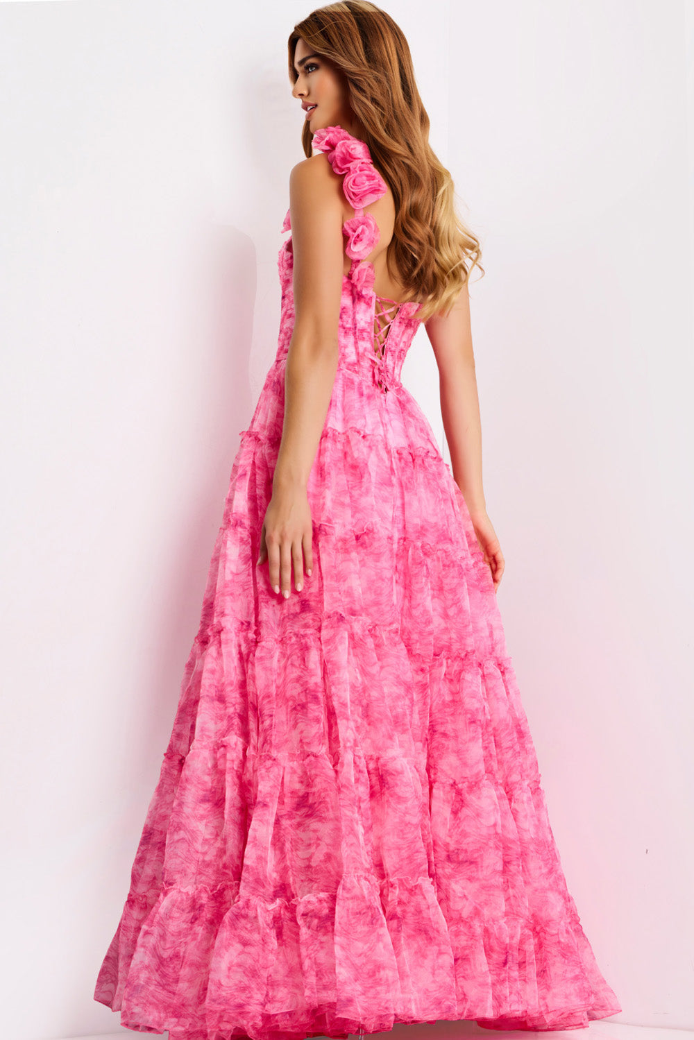 Jovani 49074 Pink tiered prom dress with floral accents and lace-up back, back view.