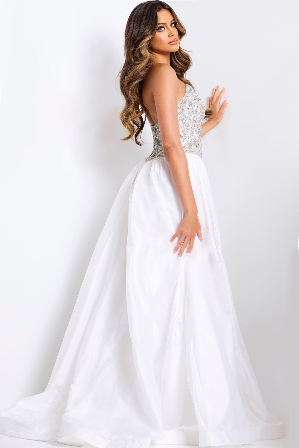 Jovani 49247 White formal gown with beaded bodice and flowing skirt, side view.