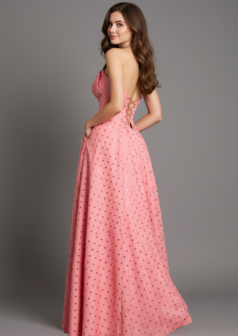 Jovani 49340 Salmon formal gown with a lace-up back and polka dot detailing, side view.