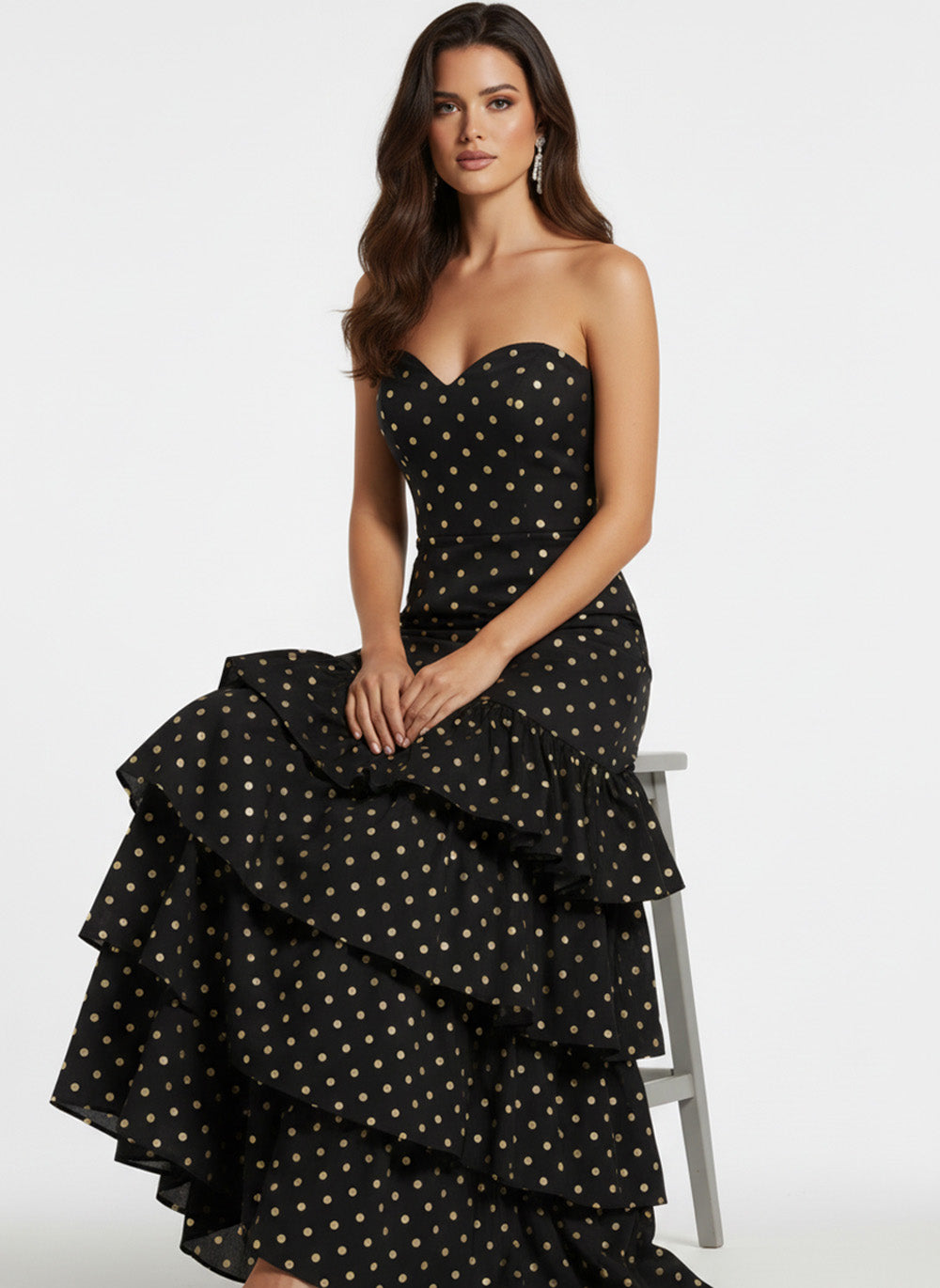 Jovani 49419 Black and gold polka dot prom dress with a fitted bodice and ruffled skirt.