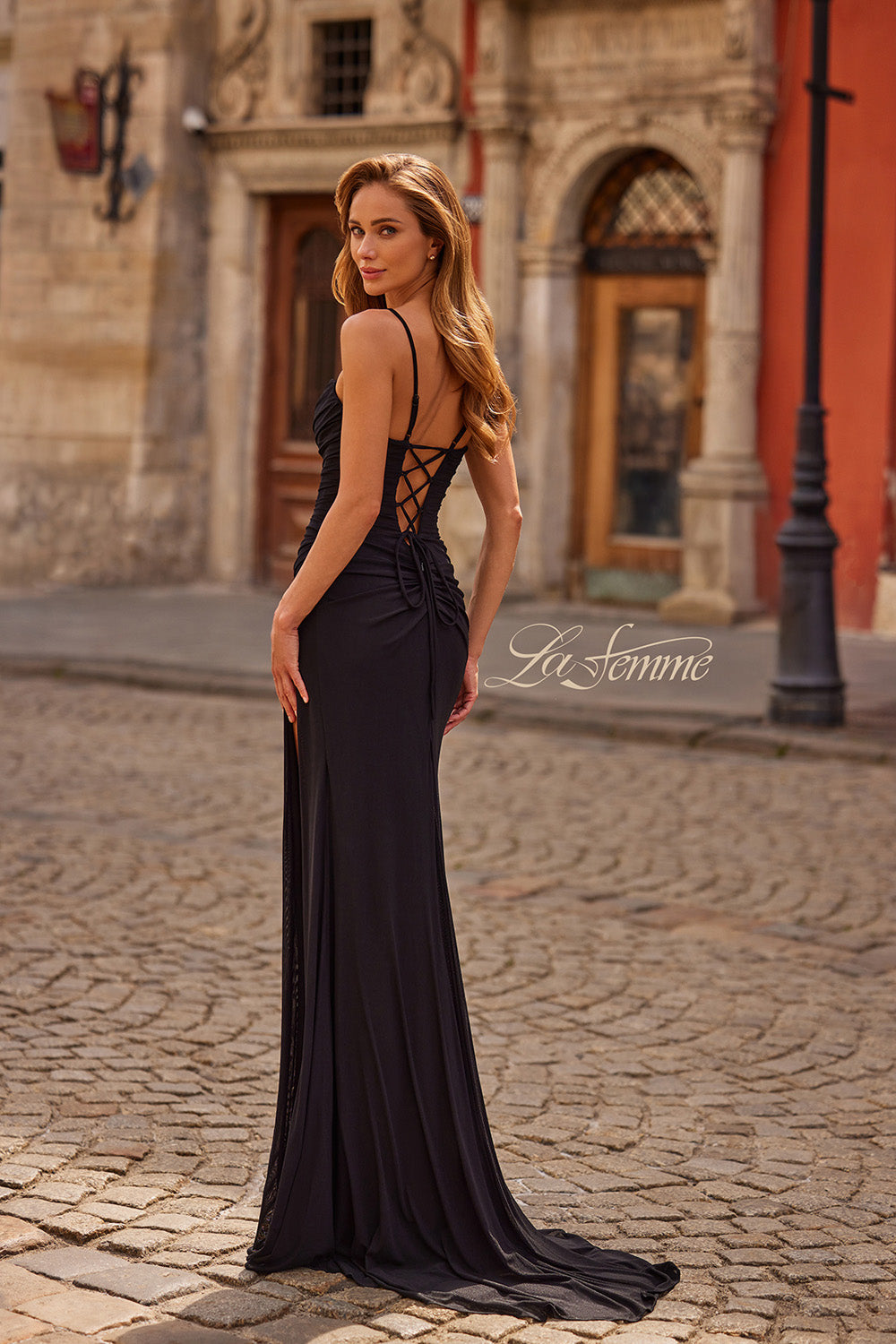 La Femme 33298 Black fitted prom dress with a lace-up back and elegant train, side view.