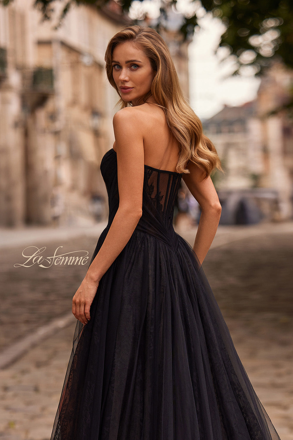 La Femme 33307 Black tulle prom dress with a fitted bodice and lace-up back, back view.
