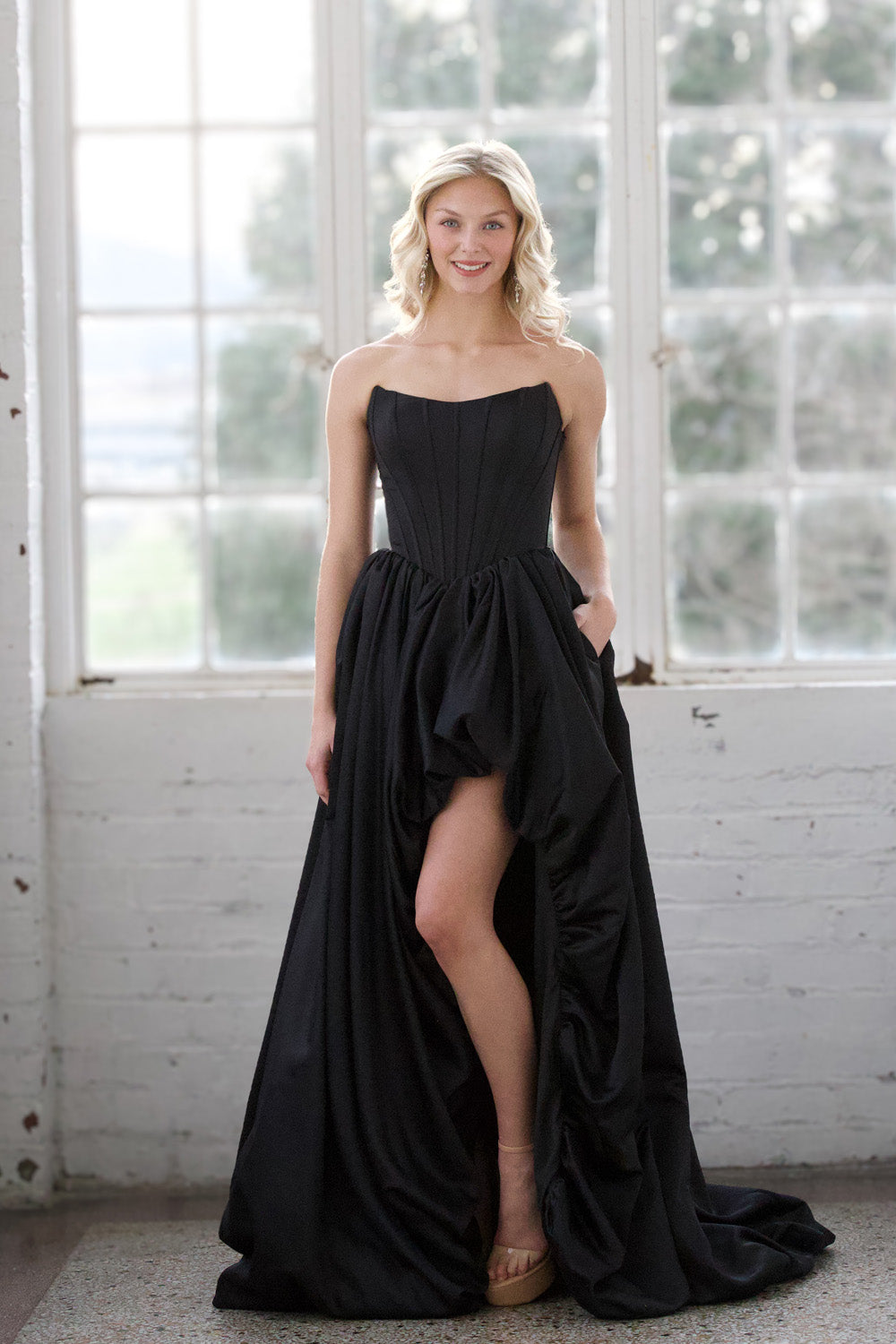 Miah Vega 24601 Black mermaid prom dress with a high slit and strapless neckline.