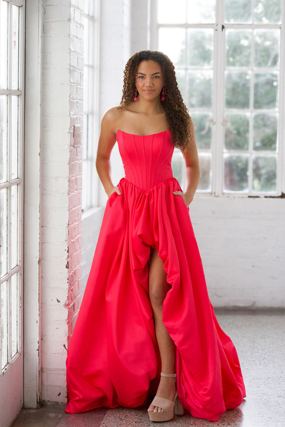 Miah Vega 24601 Bright pink prom dress with a fitted bodice and high slit, front view.