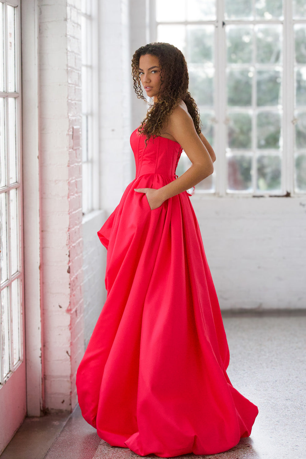 Miah Vega 24601 Bright pink ballgown with pockets and a strapless design, side view prom dress.