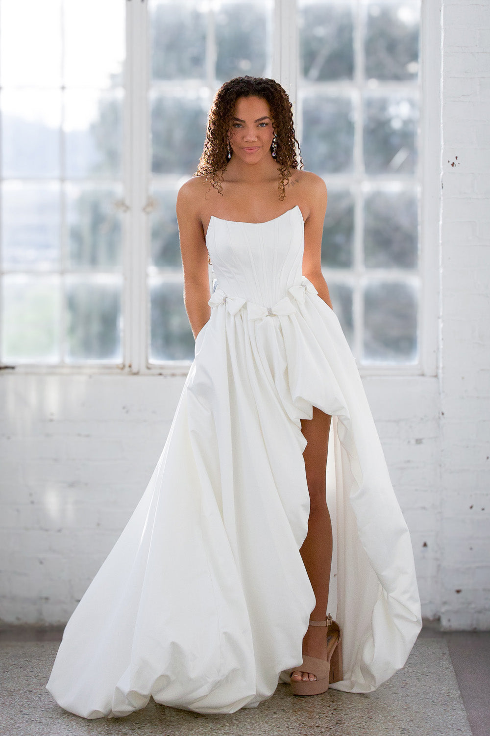 Miah Vega 24601 White A-line prom dress with a high slit and strapless neckline.