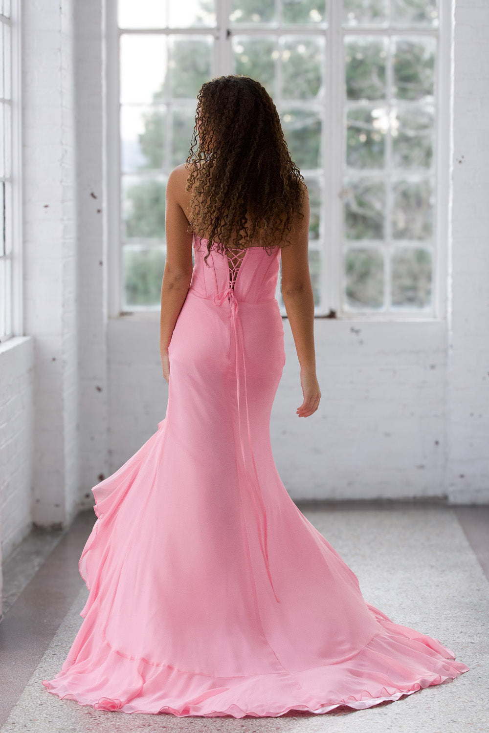 Miah Vega 24603 Light pink mermaid prom dress with a lace-up back, back view.