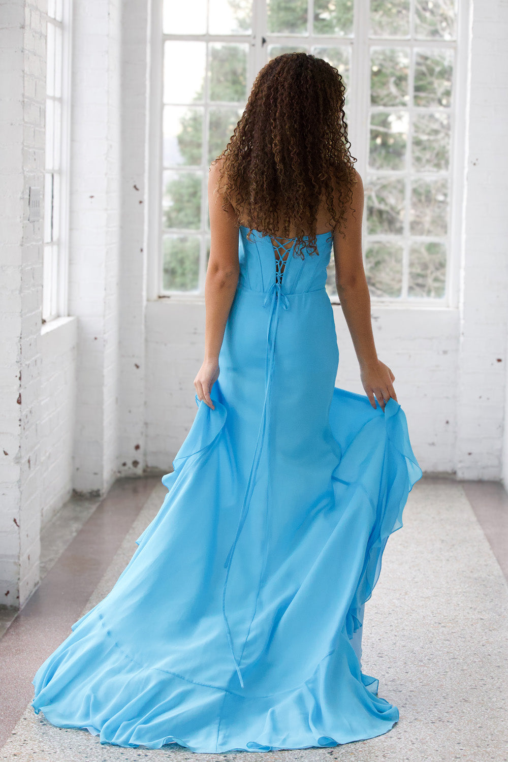 Miah Vega 24603 Light turquoise mermaid prom dress with a lace-up back, back view.