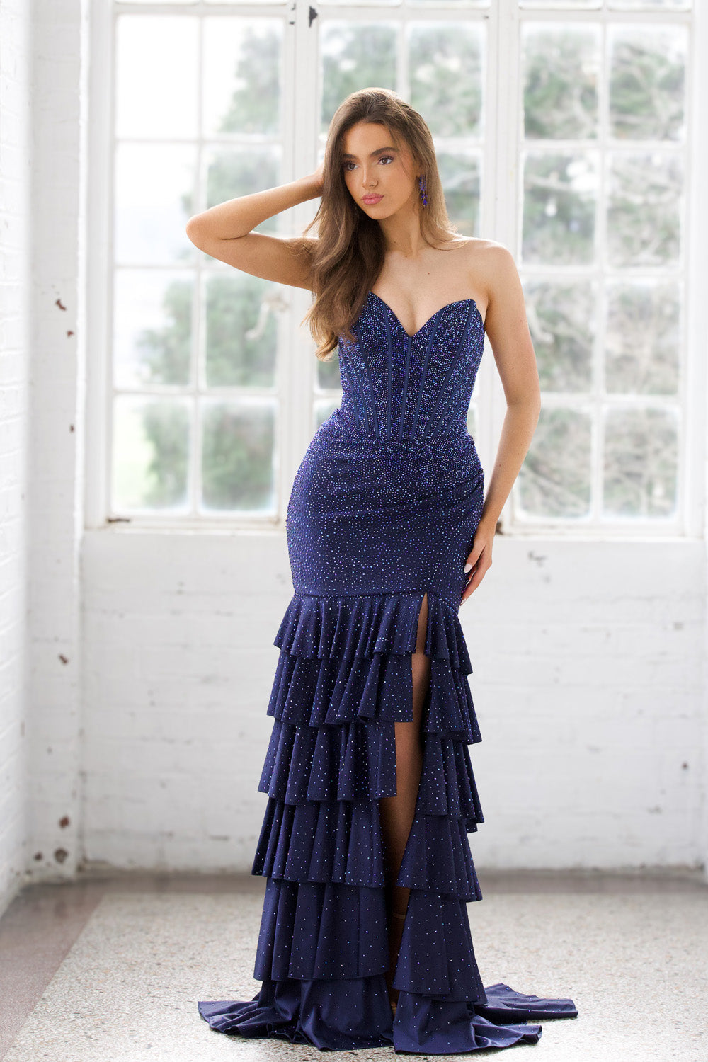 Miah Vega 24606 Navy mermaid prom dress with a thigh-high slit and sparkling beaded detailing.