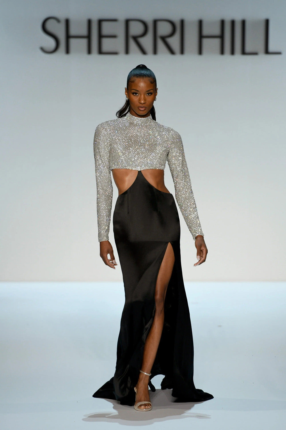 Sherri Hill 46718 black white beaded high neck long sleeve crop bodice with black satin floor length skirt and side cutouts front view