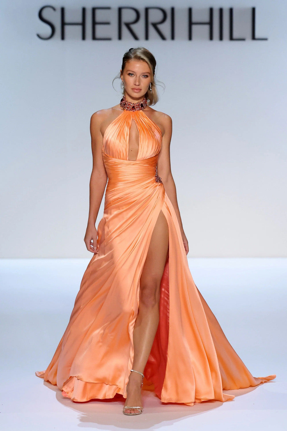 Sherri Hill 46726 coral satin A-line halter gown with deep keyhole ruched bodice and high front split