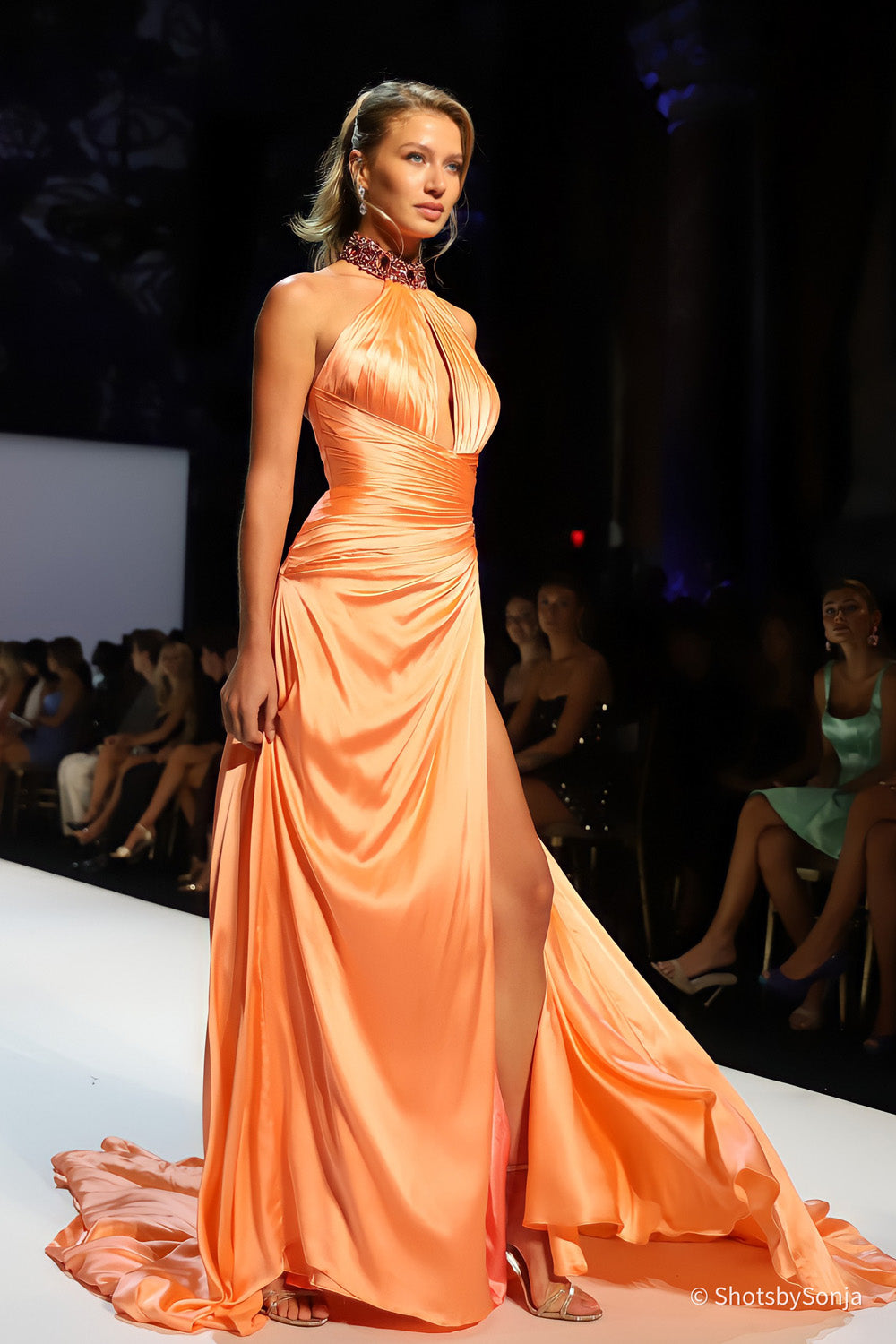Sherri Hill 46726 coral ruched halter gown with beaded hip detail and sweeping satin skirt on runway