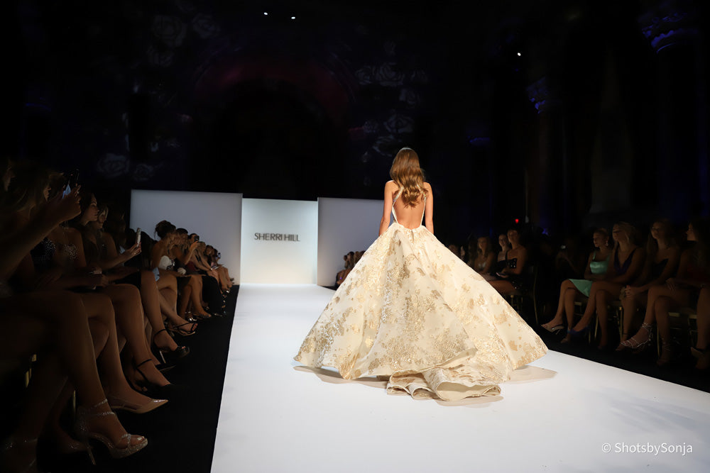 Sherri Hill 46751 ivory gold cathedral overskirt with gold floral weave trailing on runway floor