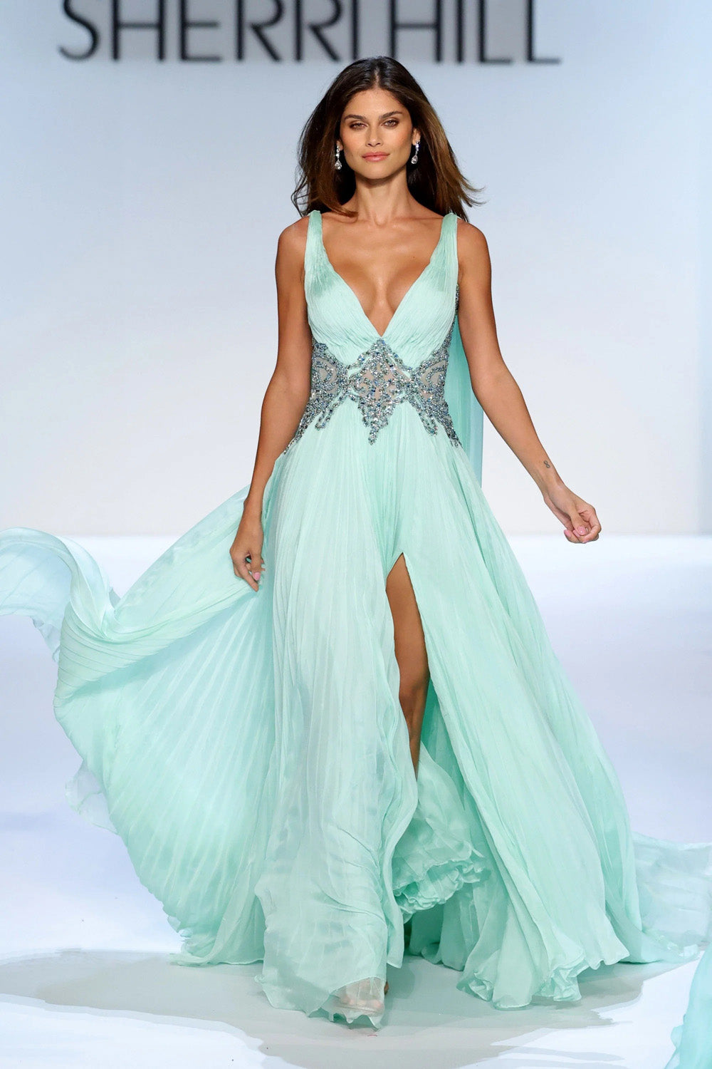 Sherri Hill 46755 mint chiffon A-line gown with deep V-neckline and beaded waist band on runway