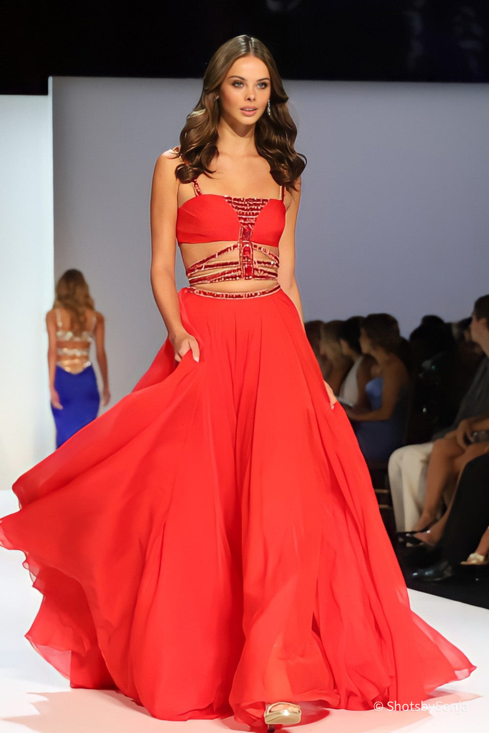 Sherri Hill 58552 red chiffon A-line gown with beaded cage midriff and ruched sweetheart bodice on runway