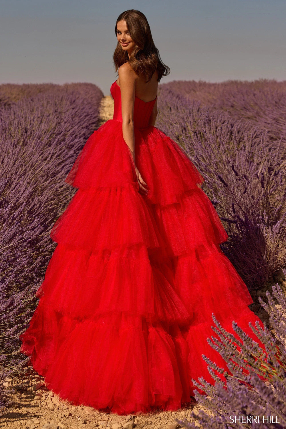 Sherri Hill 58631 red tiered tulle ball gown with structured corset bodice shown from back